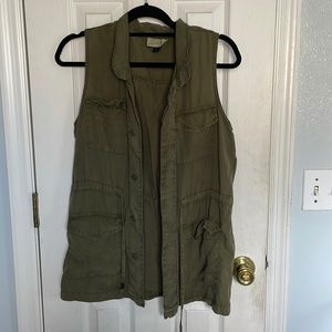 this is a button up vest type of top, and the color is art green